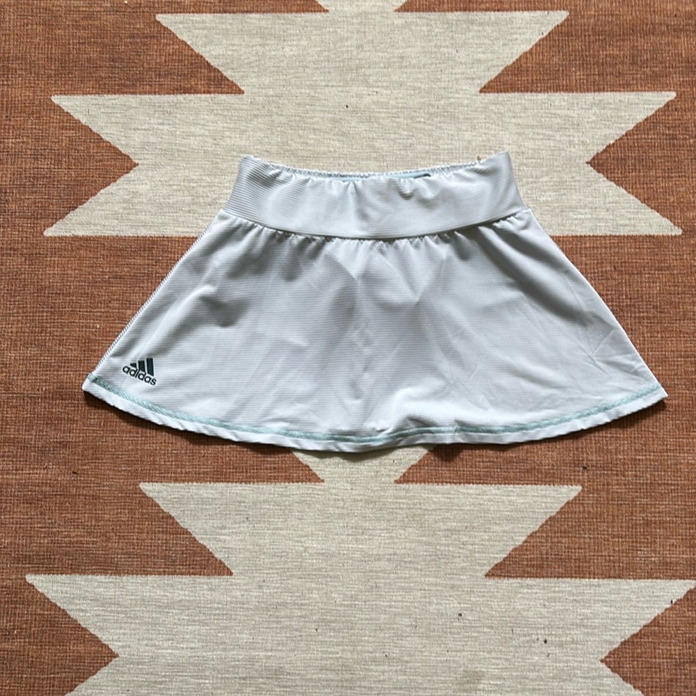 Small Adidas blue and white striped tennis skirt.